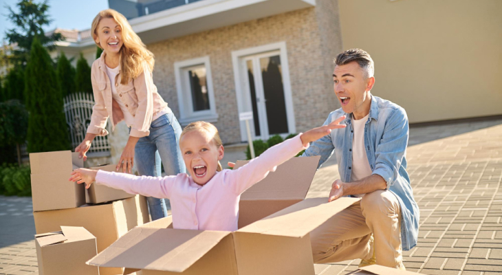 Two parents and kids happy in a moving box